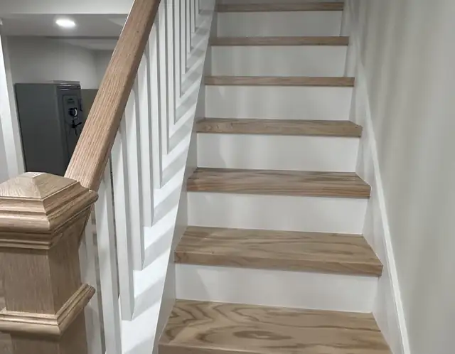 Basement staircase with oak treads, white risers and painted handrail