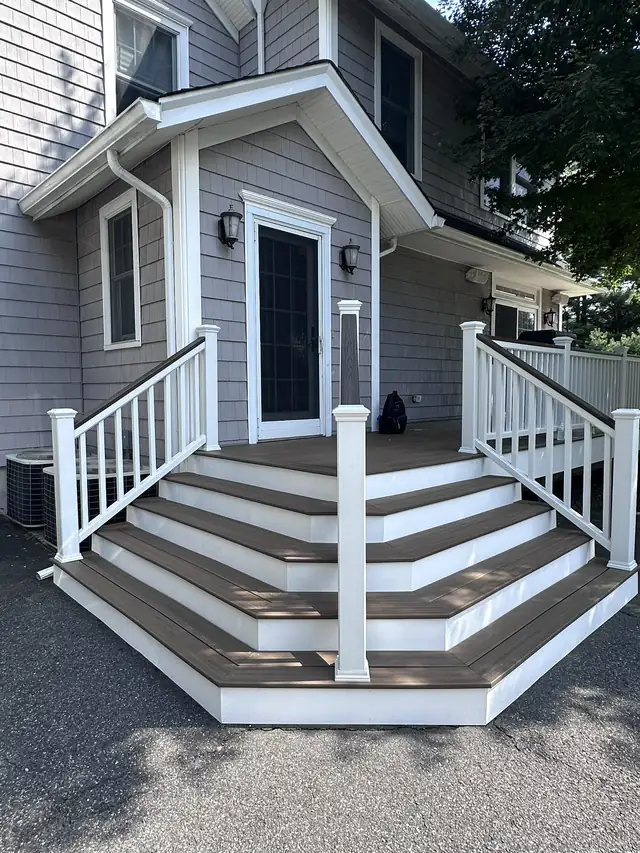 Cascading composite entry stairs with dark treads and white railings in Glen Rock, NJ
